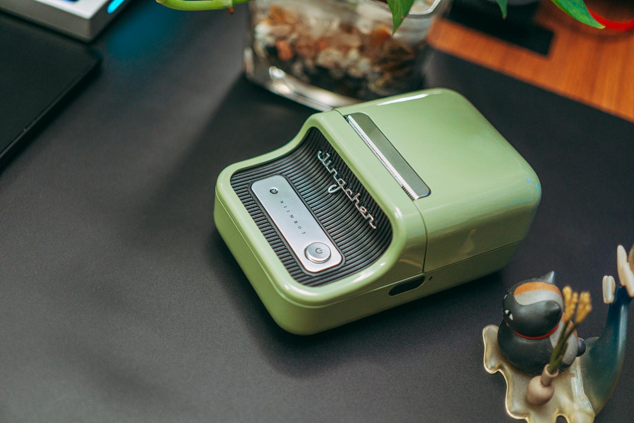 Stylish green label printer using wireless technology on a modern desk setup.